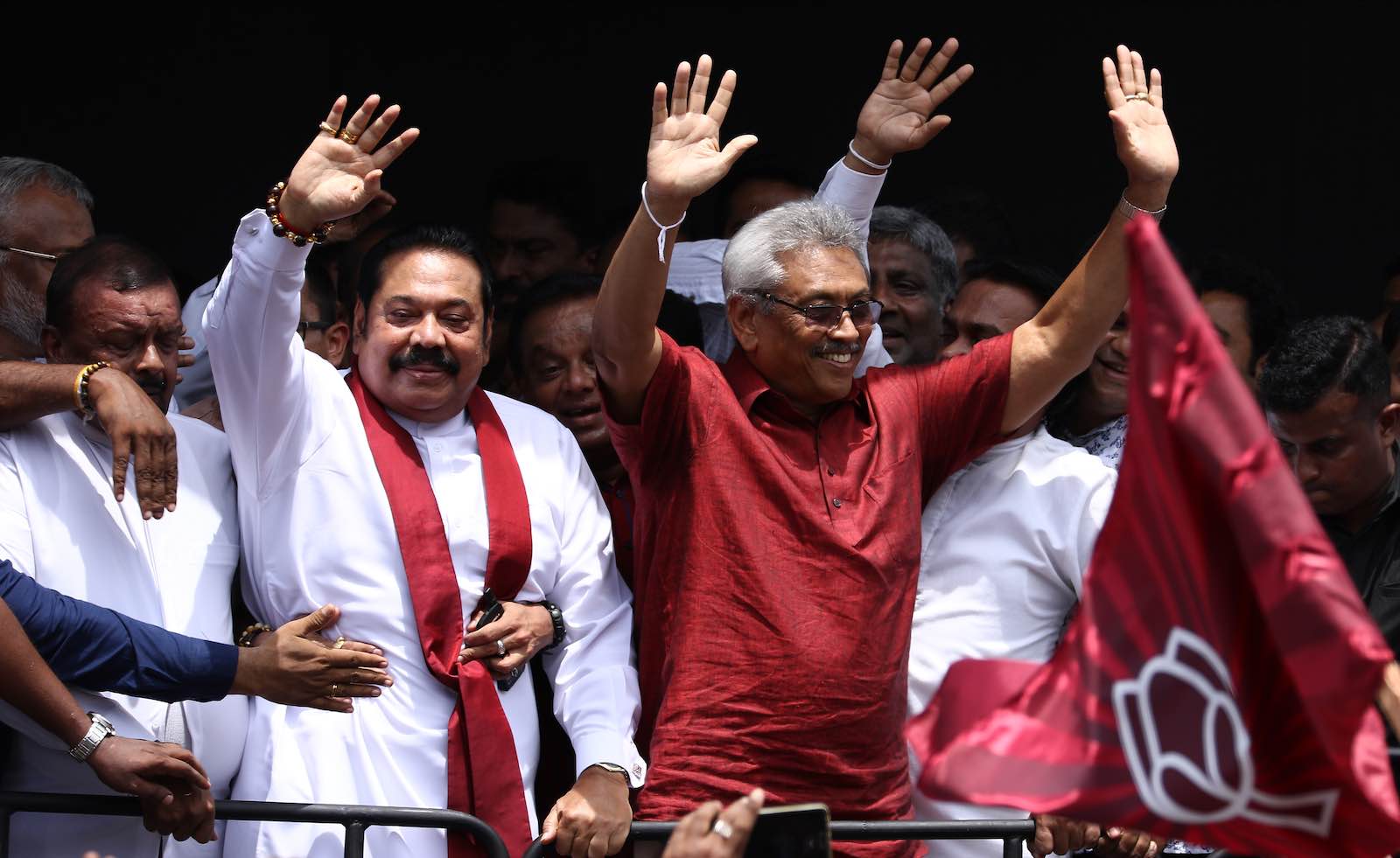 Sri Lankan presidential candidate Gotabaya Rajapaksa (wearing a Red shirt) and his brother, former president Mahinda Rajapaksa (L) acknowledge their supporters after submitting nominations for the upcoming presidential election on Monday 7 October 2019.  (Photo by Tharaka Basnayaka/NurPhoto via Getty Images)