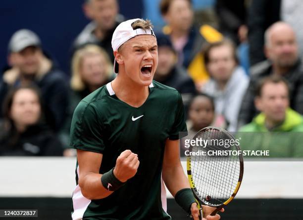 Denmark's Holger Rune reacts as he plays against Netherlands' Botic van de Zandschulp (not pictured) during the men's singles final tennis match of the ATP Tennis Open in Munich, southern Germany on May 1, 2022. - Holger Rune, 19, won his first title at the Munich tournament, beating Netherlands' Botic van de Zandschulp by retirement on May 1. Rune (70th in the world) was down 4-3 in the first set when his opponent (40th) retired. (Photo by Christof STACHE / AFP) (Photo by CHRISTOF STACHE/AFP via Getty Images)