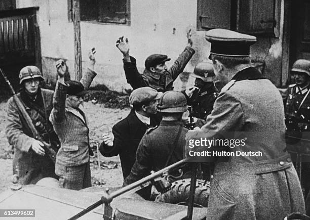 Poles are searched by SS soldiers at a Gestapo headquarters in Poland. (Photo by ? Hulton-Deutsch Collection/CORBIS/Corbis via Getty Images)