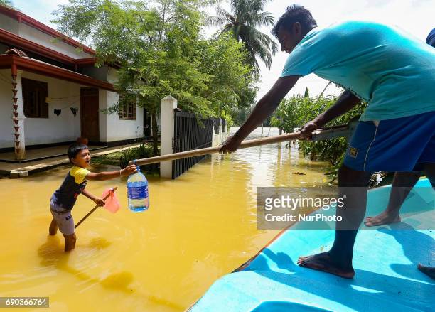 A  Sri Lankan child reaches out to get a bottled drinking water container given by a Sri Lankan Navy solider at Godagama, Matara, southern part of Sri Lanka on Tuesday 30 th May 2017. (Photo by Tharaka Basnayaka/NurPhoto via Getty Images)