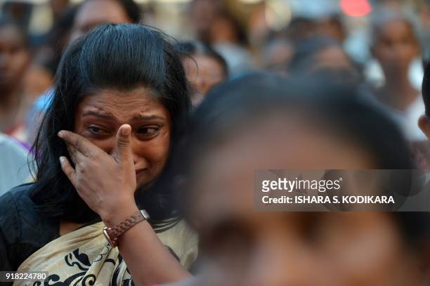 Sri Lankan Tamil women reacts during a gathering to remember their loved ones missing for nearly a decade since the end of the countrys drawn out separatist war in the capital Colombo on February 14, 2018.The women were marking what they called the missing lovers day to coincide with the Valentines Day to draw the spot light on thousands of people still listed as missing in the island despite the end of the war. / AFP PHOTO / ISHARA S. KODIKARA        (Photo credit should read ISHARA S. KODIKARA/AFP via Getty Images)